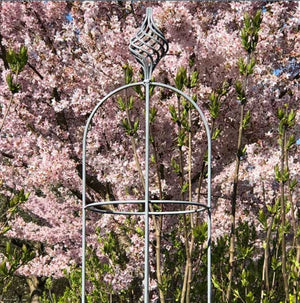 elegance obelisk with pink flowers in the background 