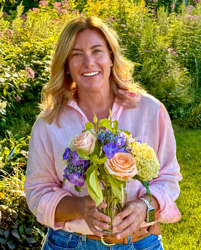 Woman holding a bouquet of flowers in a garden