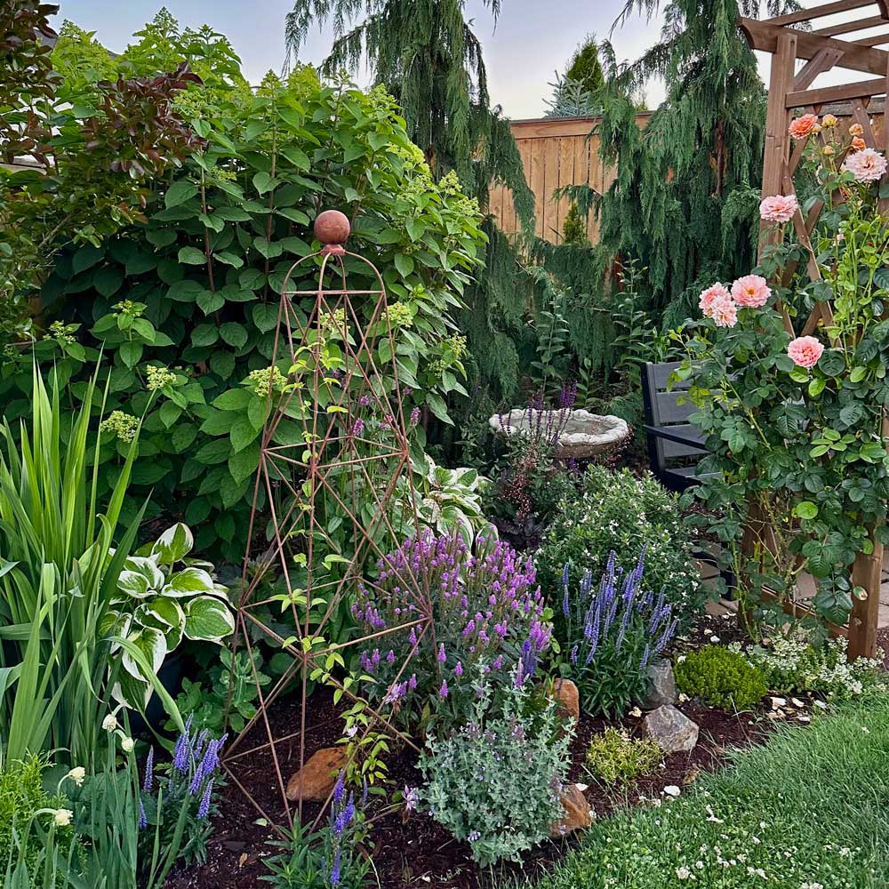 a king obelisk in a flowerbed surrounded by plants